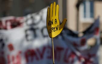 A protestors holds a handshaped placard which reads as ' no to Le Pen' during a demonstration 'against racism and fascism' in Paris on April 16, 2022. (Photo by Geoffroy VAN DER HASSELT / AFP) (Photo by GEOFFROY VAN DER HASSELT/AFP via Getty Images)