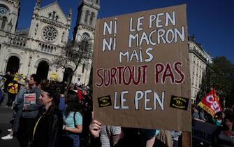 A protestor holds a placard which translates as 'nor Macron, nor Le Pen - not at all Le Pen' during a demonstration 'against racism and fascism' in Paris on April 16, 2022. (Photo by GEOFFROY VAN DER HASSELT / AFP) ( Photo by GEOFFROY VAN DER HASSELT / AFP via Getty Images)
