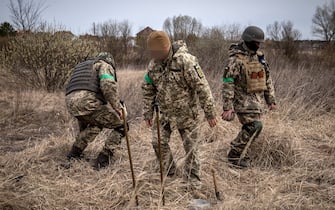Members of a bomb disposal squad walk in a mine field near Brovary, northeast of Kyiv, on April 14, 2022, amid Russia's military invasion launched on Ukraine.  - Russia called off its northern offensive to take Kyiv at the end of March, and since then Ukrainian citizens and soldiers have returned to the land they occupied.  In recent weeks AFP has seen countless unexploded munitions lying in the streets of towns and villages north-east and north-west of the capital, abandoned or mislaid in the hasty withdrawal.  (Photo by FADEL SENNA / AFP) (Photo by FADEL SENNA / AFP via Getty Images)