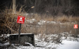 This photograph taken near Donetsk, capital of a self-proclaimed Donetsk People's Republic (DPR) in eastern Ukraine, on January 18, 2022, shows landmine warning signs in the village of Vesyoloye.  (Photo by Alexander NEMENOV / AFP) (Photo by ALEXANDER NEMENOV / AFP via Getty Images)