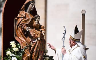Pope Francis goes to touch a sculpture of the Virgin Mary and the Christ Child at the end of the Easter mass on April 17, 2022 at St. Peter's square in The Vatican. (Photo by Tiziana FABI / AFP) (Photo by TIZIANA FABI/AFP via Getty Images)