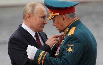 SAINT PETERSBURG, RUSSIA - JULY,25 (RUSSIA OUT): Russian President Vladimir Putin (L) talks to Defence Minister Sergei Shoigu (R) during the military parade marking the Russia's Navy Day, on July,25,2021, in Saint Petersburg, Russia. The Navy Day military parade held in St.Petersburg, despite the coronavirus (COVID-19) rising pandemy. (Photo by Mikhail Svetlov/Getty Images)