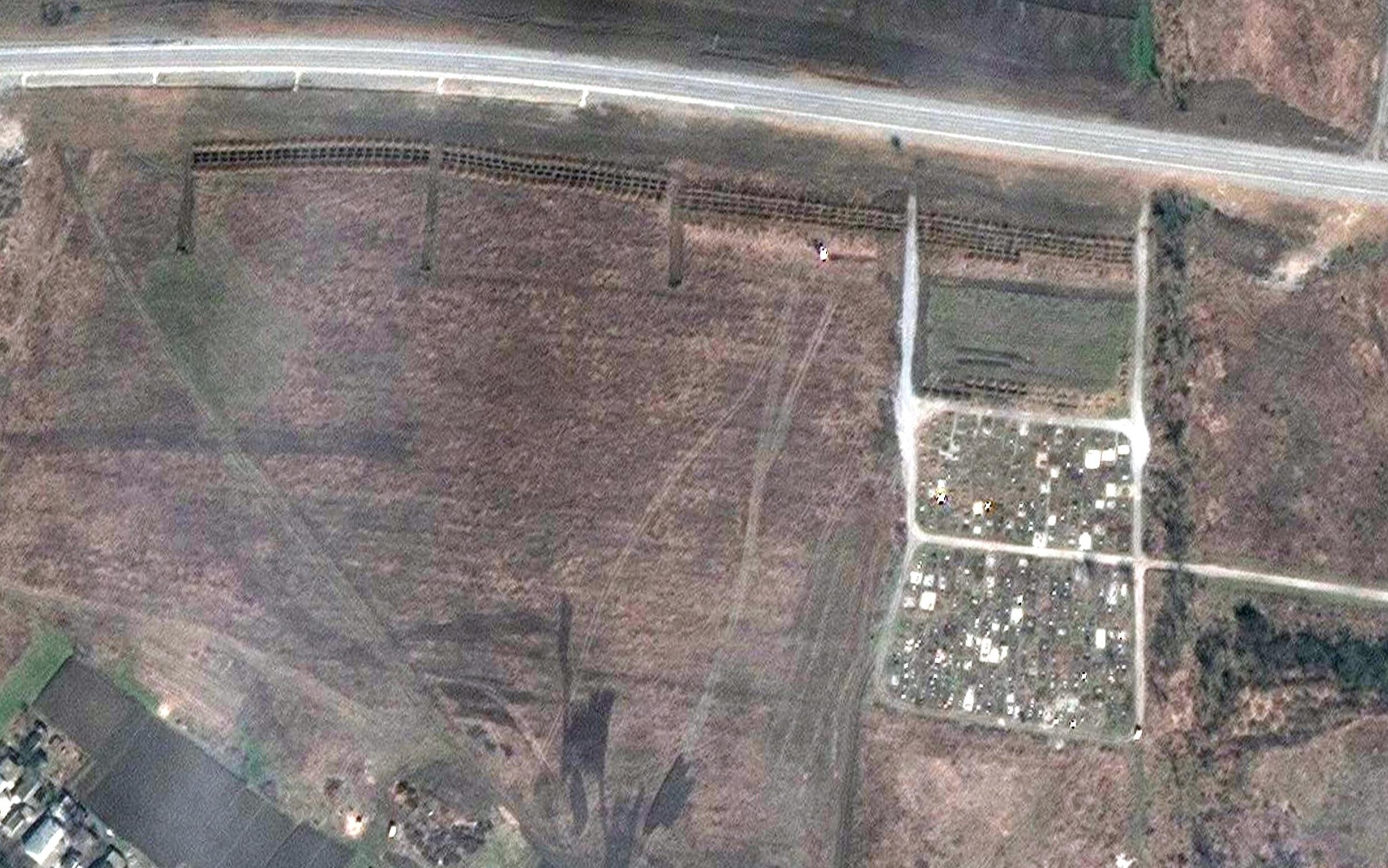 +++ RPT CON TITOLO DIVERSO +++ epa09900942 A handout satellite image made available by Maxar Technologies claims to show a mass grave site adjacent to an existing village cemetery on the northwestern edge of Manhush, some 20 kilometers west of Mariupol, Ukraine, 03 April 2022 (issued 21 April 2022). Maxar has reviewed satellite images from mid-March through mid-April, and indicate that the expansion of the new set of graves began between 23 to 26 March 2022 and continued to expand. The graves are aligned in four sections of linear rows (measuring approximately 85 meters per section) and contain more than 200 new graves, Maxar states.  EPA/MAXAR TECHNOLOGIES HANDOUT -- MANDATORY CREDIT: SATELLITE IMAGE 2022 MAXAR TECHNOLOGIES -- THE WATERMARK MAY NOT BE REMOVED/CROPPED -- HANDOUT EDITORIAL USE ONLY/NO SALES