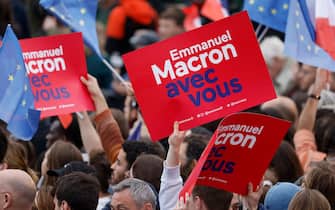 Supporters hold banners reading "Emmanuel Macron with You" prior to the arrival of French President and La Republique en Marche (LREM) party candidate for re-election Emmanuel Macron, at the Champ de Mars, in Paris, on April 24, 2022. (Photo by Ludovic MARIN / AFP) (Photo by LUDOVIC MARIN/AFP via Getty Images)