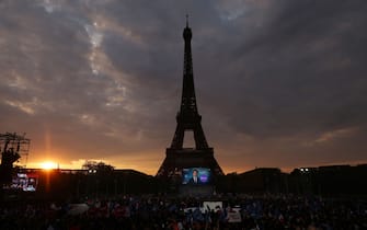 TOPSHOT - This illustration picture shows the stage and supporters prior to the arrival of French President and La Republique en Marche (LREM) party candidate for re-election Emmanuel Macron, at the Champ de Mars, in Paris, on April 24, 2022. (Photo by Thomas COEX / AFP) (Photo by THOMAS COEX/AFP via Getty Images)