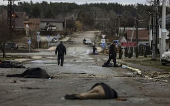 EDITORS NOTE: Graphic content / TOPSHOT - Bodies lie on a street in Bucha, northwest of Kyiv, as Ukraine says Russian forces are making a "rapid retreat" from northern areas around Kyiv and the city of Chernigiv, on April 2, 2022. - The bodies of at least 20 men in civilian clothes were found lying in a single street Saturday after Ukrainian forces retook the town of Bucha near Kyiv from Russian troops, AFP journalists said. Russian forces withdrew from several towns near Kyiv in recent days after Moscow's bid to encircle the capital failed, with Ukraine declaring that Bucha had been "liberated". (Photo by RONALDO SCHEMIDT / AFP) (Photo by RONALDO SCHEMIDT/AFP via Getty Images)