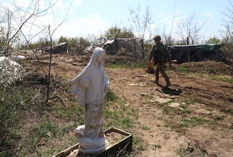 epa09911101 Ukrainian serviceman walks past a sculpture next to their position near city of Popasna not far from Luhansk, Ukraine, 26 April 2022 amid the Russian invasion. Russian troops entered Ukraine on 24 February resulting in fighting and destruction in the country and triggering a series of severe economic sanctions on Russia by Western countries.  EPA/STR