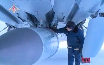 epa09772118 A handout still image taken from handout video made available by the Russian Defense ministry press-service shows Russian servicemen examines a Kinzhal hypersonic missiles before a flight of the MiG-31K fighter jet during the Russian strategic deterrence forces exercises in Russia, 19 February 2022 Russian President Vladimir Putin opens exercises of the Russian strategic deterrence forces with launches of the ballistic missiles.  Russian Navy ships of the Northern and Black Sea Fleets launched 'Kalibr' cruise missiles and 'Zirkon' hypersonic missiles at sea and ground targets during scheduled exercises of the strategic deterrence forces on Saturday.  The 'Yars' intercontinental ballistic missile was launched from Plesetsk at the Kura training ground.  EPA / RUSSIAN DEFENSE MINISTRY PRESS SERVICE / HANDOUT HANDOUT EDITORIAL USE ONLY / NO SALES