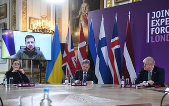 Volodymyr Zelenskiy, Ukraine's president, addresses via video link, attendees including Katrin Jakobsdottir, Iceland's prime minister, left, Sauli Niinisto, Finland's president, center, and Boris Johnson, U.K. prime minister, at the Joint Expeditionary Force (JEF) Summit in London, U.K., on Tuesday, March 15, 2022. The U.K. government are hosting the summit with Nordic and Baltic leaders in a push to bolster European resilience and defence, according the government website. Photographer: Neil Hall/EPA/Bloomberg