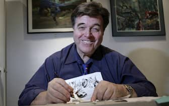 FOR USE WITH STORY by Luis Torres de la Llosa, US-ART-COMICS-FASHION-SUPERHEROES Neal Adams draws in his office at Continuity Studios in New York on April 14, 2008. Adams is creating nine new issues of Batmn for DC Comics.  AFP PHOTO / Nicholas ROBERTS (Photo credit should read NICHOLAS ROBERTS / AFP via Getty Images)