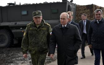 epa07016408 Russian President Vladimir Putin (C) and General of Army Valery Gerasimov (L) attend Russia's biggest ever military maneuvers, Vostok 2018 (East 2018) on the military range Tsogol, Zabaykalsky Kray, Russia, 13 September 2018. The exercises are the biggest since 1981 and will including 297,000 military servicemen, more than 1,000 different military aircrafts, up to 36,000 vehicles, plus 80 warships. Forces from China and Mongolia will take part in the exercises, which will run from 11 to 17 September.  EPA/ALEXEY NIKOLSKY / SPUTNIK / POOL MANDATORY CREDIT