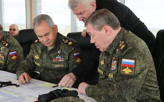 epa09152916 A handout photo made available by the press service of the Russian Defence Ministry shows Russian Defense Minister Army General Sergei Shoigu (L) and Chief of the Russian General Staff Valery Gerasimov (R) attend the main stage of the mixed exercise of the Russian Armed Forces at the at Opuk range  in Crimea, 22 April 2021. Units of the combined arms army, air force and air defen e formations, warships and ships, military units of the coastal forces of the Black Sea Fleet, part of the forces of the Caspian Flotilla and airborne units take part in the military exercises at the Opuk training ground.  EPA/VADIM SAVITSKY / RUSSIAN DEFENCE MINISTRY / HANDOUT MANDATORY CREDIT / HANDOUT EDITORIAL USE ONLY/NO SALES