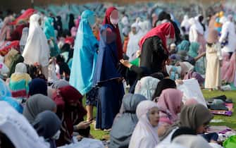 epa09921855 Indonesian Muslims attend Eid al-Fitr prayers at a field in Depok, Indonesia, 02 May 2022. Muslims around the world are celebrating Eid al-Fitr, the three day festival marking the end of the Muslim holy fasting month of Ramadan EPA / ADI WEDA