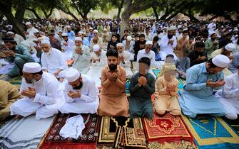 epa09921992 People offer Eid al-Fitr prayers in Peshawar, Pakistan, 02 May 2022. Muslims around the world celebrate Eid al-Fitr, the three days festival marking the end of Ramadan. Eid al-Fitr is one of the two major holidays in the Islamic calendar.  EPA/BILAWAL ARBAB