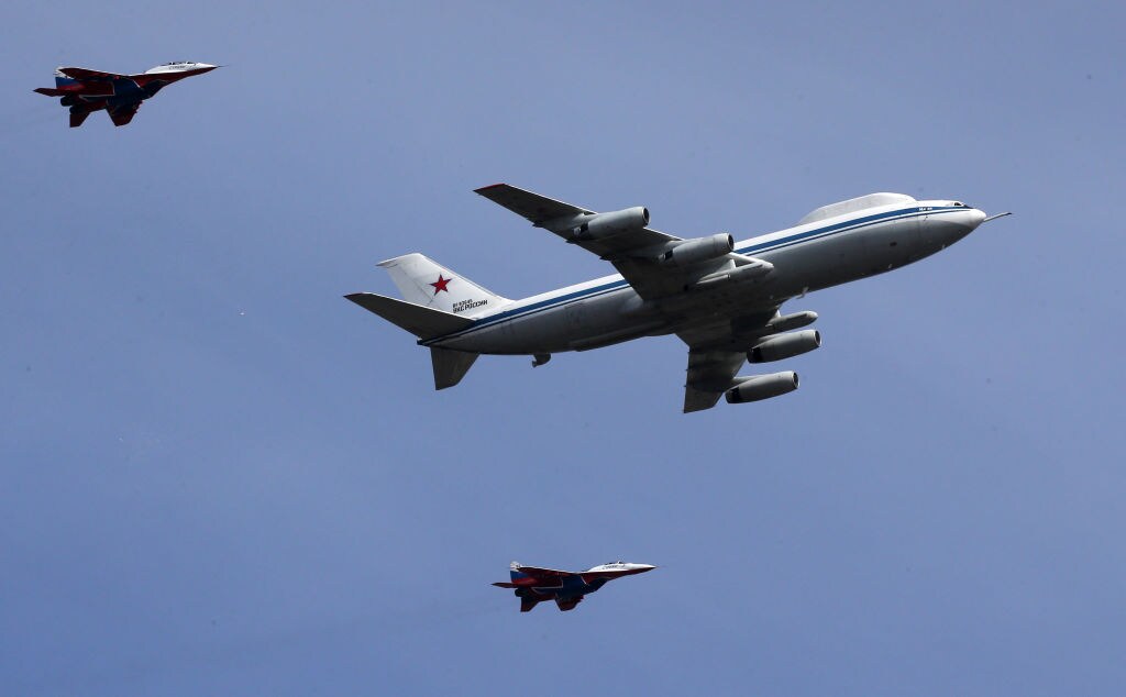 1240064882 ALABINO, RUSSIA - ARRIL 18: (RUSSIA OUT) The Ilyushin IL-80 (NATO reporting name: Maxdome), an airbond command and control aircraft, followed by two Mikoyan MIG-29 jet fighters fly over the polygon during the rehearsals for the Victory Day Military Parade at the polygon, on April 18, 2022 in Alabino, outside of Moscow, Russia. About 12,000 soldiers and officers are expected to take pat at the Red Square Victory Day Military Parade, planned on May 9. (Photo by Contributor/Getty Images)