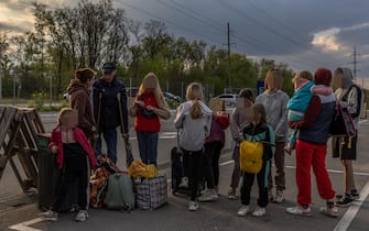 epa09923010 Families gather after arriving from the Russian-occupied Tokmak town, at the evacuation point in Zaporizhzhia, Ukraine, 02 May 2022.  On 02 May, thousands of people who were still in Mariupol and other areas in South Ukraine occupied by the Russian army, waited to be evacuated to Ukraine's controlled area by buses and their own cars.  EPA/ROMAN PILIPEY
