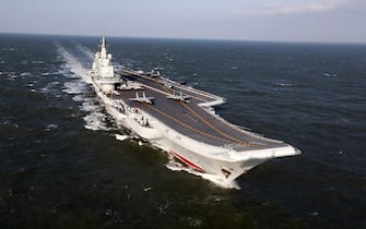 This photo taken on December 24, 2016 shows the Liaoning, China's only aircraft carrier, sailing during military drills in the Pacific. 
Taiwan's defence minister warned on December 27 that enemy threats were growing daily after China's aircraft carrier and a flotilla of other warships passed south of the island in an exercise as tensions rise. / AFP / STR / China OUT        (Photo credit should read STR/AFP via Getty Images)