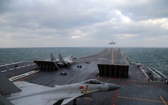 This photo taken on December 23, 2016 shows Chinese J-15 fighter jets being launched from the deck of the Liaoning aircraft carrier during military drills in the Yellow Sea, off China's east coast. 
Taiwan's defence minister warned on December 27 that enemy threats were growing daily after China's aircraft carrier and a flotilla of other warships passed south of the island in an exercise as tensions rise. / AFP / STR / China OUT        (Photo credit should read STR/AFP via Getty Images)