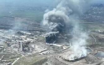 epa09896967 A frame grab from an undated handout drone video first published by DPR militia commander Alexander Khodakovsky and made available by the Mariupol City Council shows smoke rising from the Azovstal steel plant during airstrikes in Mariupol, eastern Ukraine, 18 April (issued 19 April 2022). The Russian Defence Ministry on 19 April 2022 issued a statement calling on the Ukrainian forces in Mariupol "to cease any hostilities and lay down their arms. All who lay down their weapons are guaranteed the preservation of life." The city council on 18 April 2022 via their official Telegram channel said that at least 1,000 civilians are sheltering in the underground shelters of the metallurgical plant, and that heavy bombs were dropped on the Azovstal plant by Russian forces.  EPA/MARIUPOL CITY COUNCIL HANDOUT  HANDOUT EDITORIAL USE ONLY/NO SALES