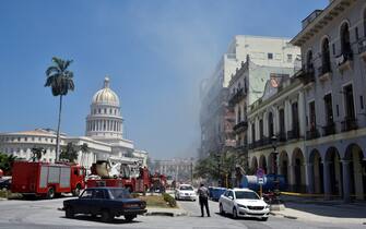 Rescuers work after an explosion in the Saratoga Hotel in Havana, on May 6, 2022. - A powerful explosion Friday destroyed part of a hotel under repair in central Havana, AFP witnessed, with no casualties immediately reported. (Photo by ADALBERTO ROQUE / AFP) (Photo by ADALBERTO ROQUE/AFP via Getty Images)
