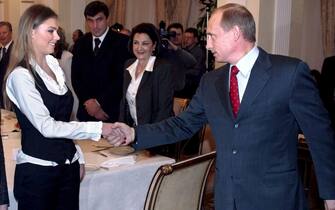 (FILE) A file picture dated 10 March 2004 of Russian President Vladimir Putin (R) shaking hands with Russian gymnasts Alina Kabayeva at the presidential residence in Novo-Ogaryovo outside Moscow, Russia. 
ANSA/SERGEI CHIRIKOV