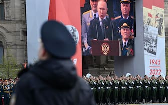 A screen shows Russian President Vladimir Putin giving a speech as servicemen line up on Red Square during the Victory Day military parade in central Moscow on May 9, 2022. - Russia celebrates the 77th anniversary of the victory over Nazi Germany during World War II. (Photo by Kirill KUDRYAVTSEV / AFP) (Photo by KIRILL KUDRYAVTSEV/AFP via Getty Images)