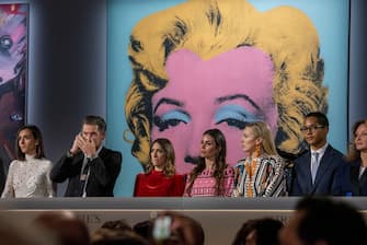 epa09936995 Staffers work the phones for bids on 'Shot Sage Blue Marilyn' by Andy Warhol during an Evening Sale of works from The Collection of Thomas and Doris Amman at Christie's Auction House in New York, New York, USA, 09 May 2022.  EPA/SARAH YENESEL
