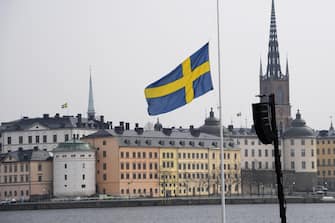 epa05900906 A Swedish flag at half mast at the official ceremony at Stockholm City Hall, in Stockholm, Sweden, 10 April 2017. The members of the Swedish Royal family are joining politicians and members of the public for a one minute of silence at the official ceremony, at noon, to remember the victims of the terror attack on Drottninggatan, Stockholm, 07 April 2017.  EPA/ANDERS WIKLUND  SWEDEN OUT