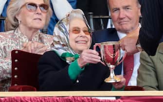 WINDSOR, ENGLAND - MAY 13: Queen Elizabeth II receives the winners cup at The Royal Windsor Horse Show at Home Park on May 13, 2022 in Windsor, England. The Royal Windsor Horse Show, which is said to be the Queen’s favourite annual event, takes place as Her Majesty celebrates 70 years of service. The 4-day event will include the “Gallop Through History” performance, which forms part of the official Platinum Jubilee celebrations. (Photo by Chris Jackson/Getty Images)