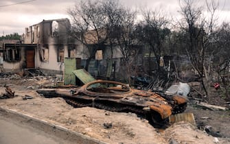 UKRAINE - APRIL 21, 2022 - A destroyed Russian military vehicle is pictured near a building ruined by Russian troops near the Chernihiv highway, northern Ukraine.