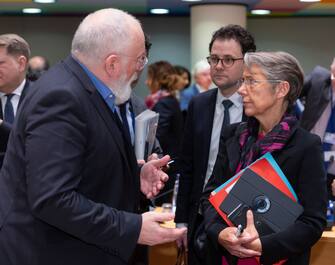 BRUSSELS, BELGIUM - MARCH 05: EU Commissioner for European Green Deal - First Vice President and Executive Vice President Frans Timmermans (L) greets the French Minister of Ecology Elisabeth Borne (R) prior an EU environment Council at the Europa, the European Council headquarter, on March 5, 2020, in Brussels, Belgium. (Photo by Thierry Monasse/Getty Images)