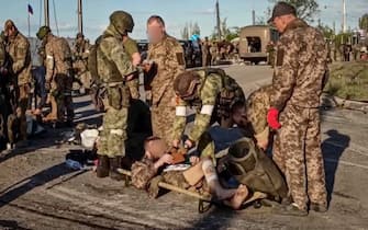 epa09952374 A handout still image taken from a handout video made available by the Russian Defence Ministry's press service shows Russian servicemen frisk Ukrainian servicemen as they are being evacuated from the besieged Azovstal steel plant in Mariupol, Ukraine, 17 May 2022. A total of 265 Ukrainian militants, including 51 seriously wounded, have laid down arms and surrendered to Russian forces, the Russian Ministry of Defence said on 17 May 2022. Those in need of medical assistance were sent for treatment to a hospital in Novoazovsk, the ministry states further. Russian President Putin on 21 April 2022 ordered his Defence Minister to not storm but to blockade the plant where a number of Ukrainian fighters were holding out. On 24 February, Russian troops invaded Ukrainian territory starting a conflict that has provoked destruction and a humanitarian crisis. According to the UNHCR, more than six million refugees have fled Ukraine, and a further 7.7 million people have been displaced internally within Ukraine since.  EPA/RUSSIAN DEFENCE MINISTRY PRESS SERVICE HANDOUT  BEST QUALITY AVAILABLE HANDOUT EDITORIAL USE ONLY/NO SALES