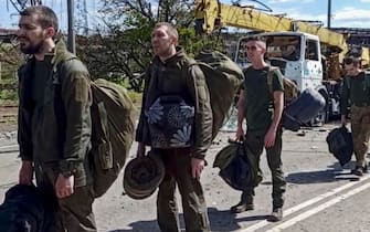 epa09962237 A still image taken from handout video made available on 21 May 2022 by the Russian Defence Ministry's press service shows Ukrainian servicemen leaving the besieged Azovstal steel plant in Mariupol, Ukraine, 20 May 2022 (issued 21 May 2022). The Chief spokesman of the Russian Defense Ministry, Major General Igor Konashenkov, said on 20 May that the Azofstal steel plant is now under full Russian army control. Russian troops entered Ukraine on 24 February 2022.  EPA/RUSSIAN DEFENCE MINISTRY PRESS SERVICE/HANDOUT BEST QUALITY AVAILABLE HANDOUT EDITORIAL USE ONLY/NO SALES