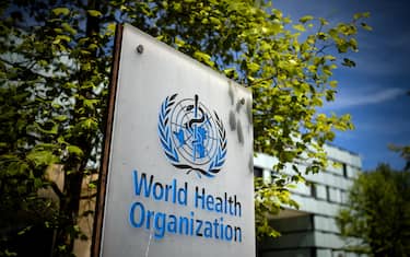 A picture taken on May 8, 2021 shows a sign of the World Health Organization (WHO) at the entrance of their headquarters in Geneva amid the Covid-19 coronavirus outbreak. (Photo by Fabrice COFFRINI / AFP) (Photo by FABRICE COFFRINI/AFP via Getty Images)
