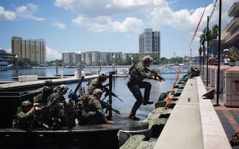 Marine Corps Forces Special Operations Command (MARSOC) Raiders and international special operations partners disembark from a Special Operations Craft Riverine (SOC-R) boat during an International Special Operations Forces capacities exercise outside the Special Operations Forces Industry Conference (SOFIC) in Tampa, Florida, U.S., on Wednesday, May 23, 2018. The conference offers the SOF community a place to interact with industry and to collaborate on the challenges, initiatives and way-ahead in delivering the most cutting-edge capabilities into the hands of SOF operators. Photographer: Luke Sharrett/Bloomberg