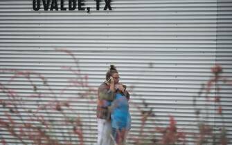 People outside Willie de Leon Civic Center in Uvalde, Texas, U.S., on Tuesday, May 24, 2022. An 18-year-old gunman opened fire Tuesday at a Texas elementary school, killing at least 18 children, officials said, and the gunman was dead. Photographer: Eric Thayer/Bloomberg
