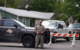 A State trooper stands seen outside of Robb Elementary School in Uvalde, Texas, on May 24, 2022. - An 18-year-old gunman killed 14 children and a teacher at an elementary school in Texas on Tuesday, according to the state's governor, in the nation's deadliest school shooting in years. (Photo by allison dinner / AFP) (Photo by ALLISON DINNER/AFP via Getty Images)