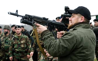 Ramzan Kadyrov proudly displays his shooting skills at a firing range in his village of Tsentoroi in front of members of his private army. Officially his army are known as the anti-terrorism squad, but everyone refers to its soldiers as Kadyrovtsy - "Kadyrov's guys". November 2005.

Ramzan was born 5 October 1976 in Tsenteroi, Chechnya, and was made Prime Minister of Chechnya in the beginning of March 2006 and leader of a powerful Chechen militia known as kadyrovtsy. He is the son of former Chechen President Akhmad Kadyrov, who was assassinated in May 2004. He has the backing of Russian President Vladimir Putin, and was awarded the Hero of Russia medal, the highest honorary title of the Russian Federation. As the head of the Chechen Presidential Security Service, Kadyrov has often been accused of being brutal, ruthless and antidemocratic; according to media and human rights groups, he was personally implicated in several instances of torture and murder. It is also rumored that he owns a private prison in his stronghold village of Tsenteroi, where he uses inmates as a punching bags. Kadyrov is known for keeping a pet lion cub, given to him as a gift after the birth of his first son, as well as a tiger and a number of a fighting dogs, and also used to own a wolf and a bear. He has only a few classes of elementary education finished; despite his lack of education, Kadyrov is a honorary member of the Russian Academy of Sciences.                                
