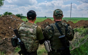 SOLEDAR, UKRAINE - 2022/05/24: Two soldiers are looking at the southern frontline from their position, which is 5 km from it. Soledar is a town in the Donetsk region, where it is being hammered by Russian artillery as it sits along the crucial road that leads out of besieged Severodonetsk. (Photo by Rick Mave/SOPA Images/LightRocket via Getty Images)