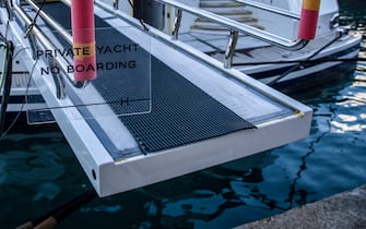 A sign reading 'private yacht, no boarding' at the end of a boat platform at the MB92 Group shipyard in Barcelona, ​​Spain, on Wednesday, Nov. 17, 2021. Luxury liners aren't going away - more than 600 large yachts are set to join the global fleet by 2025, according to industry publication Superyacht Group - but there's a push within the industry to at least try and make the boats a little bit greener.  Photographer: Angel Garcia / Bloomberg