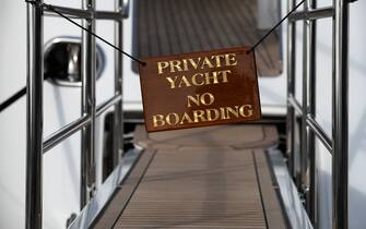 A picture shows a sign prohibiting the boarding of a yacht in the port of Cannes on October 9, 2021 in Cannes, southern France. (Photo by JOEL SAGET / AFP) (Photo by JOEL SAGET/AFP via Getty Images)
