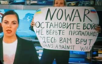 epa09826233 A woman watches a recorded feed of the Russian Channel One's evening news broadcast TV show in which an employee enters Ostankino on-air TV studio with a poster reading ''No War. Stop the war. Don't believe the propaganda. You are being lied to here" in Moscow, Russia, 15 March 2022. The on-air protest was staged on 14 March by Marina Ovsyannikova, who worked as an editor. She was taken to the Ostankino police department. A protocol was drawn up against an employee of Channel One under the article on military censorship for discrediting the Russian armed forces. On 24 February Russian troops had entered Ukrainian territory in what the Russian president declared a 'special military operation', resulting in fighting and destruction in the country, a huge flow of refugees, and multiple sanctions against Russia.  EPA/DSK