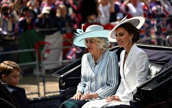Britain's Camilla, Duchess of Cornwall (C), Britain's Catherine, Duchess of Cambridge, (R) and Britain's Prince George of Cambridge travel in a horse-drawn carriage during the Queen's Birthday Parade, the Trooping the Colour, as part of Queen Elizabeth II's platinum jubilee celebrations, in London on June 2, 2022. - Huge crowds converged on central London in bright sunshine on Thursday for the start of four days of public events to mark Queen Elizabeth II's historic Platinum Jubilee, in what could be the last major public event of her long reign. (Photo by Ben Stansall / AFP) (Photo by BEN STANSALL/AFP via Getty Images)
