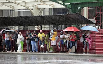 epa09994489 Several people seek shelter from the rain in Havana, Cuba, 03 June 2022. The remnant of Hurricane Agatha, which left nine dead and four missing in Mexico, is causing intense and persistent rains this Friday in western Cuba. The island's authorities have already warned about this meteorological phenomenon, which according to the US National Hurricane Center (NHC) continues to strengthen and may become the first tropical storm in the Atlantic this season.  EPA/Ernesto Mastrascusa