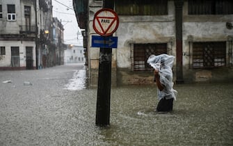 TOPSHOT - A man wades along a flooded street of Havana, on June 3, 2022. - The remnant of Hurricane Agatha is causing intense and persistent rains this Friday in the western and central provinces of Cuba. (Photo by YAMIL LAGE / AFP) ( Photo by YAMIL LAGE / AFP via Getty Images)