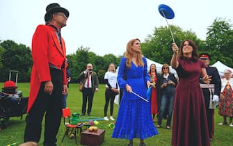 Princess Beatrice (centre) and Princess Eugenie trying their hand at plate spinning during the Big Jubilee Lunch organised by Westminster Council for local volunteer and community groups who helped during the Covid-19 pandemic, at Paddington Recreation Ground, London, on day four of the Platinum Jubilee celebrations. Picture date: Sunday June 5, 2022. (Photo by Victoria Jones/PA Images via Getty Images)
