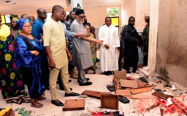 EDITORS NOTE: Graphic content / TOPSHOT - Ondo State governor Rotimi Akeredolu (3rd L) points to blood the stained floor after an attack by gunmen at St. Francis Catholic Church in Owo town, southwest Nigeria on June 5, 2022. - Gunmen with explosives stormed a Catholic church and opened fire in southwest Nigeria on June 5, killing "many" worshippers and wounding others, the government and police said. The violence at St. Francis Catholic Church in Owo town in Ondo State erupted during the morning service in a rare attack in the southwest of Nigeria, where jihadists and criminal gangs operate in other regions. (Photo by AFP) (Photo by -/AFP via Getty Images)