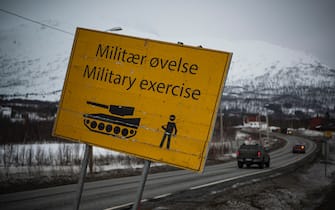 A warning sign of an ongoing military exercise is pictured next to a road leading to Narvik during the international military exercise Cold Response 22, at Setermoen, North of in Norway, on March 22, 2022. - Cold Response is a Norwegian-led winter exercise in which NATO and partner countries participate. 30,000 NATO troops are involved in the exercise that was planned long before Moscow's invasion of Ukraine. (Photo by Jonathan NACKSTRAND / AFP) (Photo by JONATHAN NACKSTRAND/AFP via Getty Images)