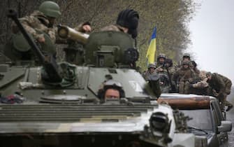 Ukrainian soldiers stand on their armoured personnel carrier (APC), not far from the front-line with Russian troops, in Izyum district, Kharkiv region on April 18, 2022, during the Russian invasion of Ukraine. (Photo by Anatolii Stepanov / AFP) (Photo by ANATOLII STEPANOV/AFP via Getty Images)