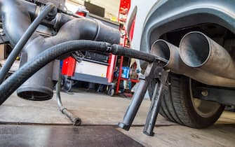 A probe of a device used for Diesel engine emission tests has been attached to an exhaust pipe of a VW Golf 2.0 TDI car in a repair shop in Frankfurt / Oder, Germany, 21 September 2015. ANSA / Patrick Pleul
